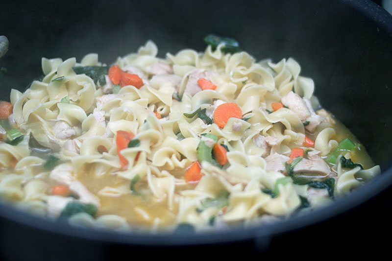 making chicken noodle soup with carrots spinach chicken bone broth and more