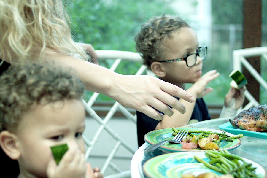 mom serving vegetables to toddlers for family dinner night